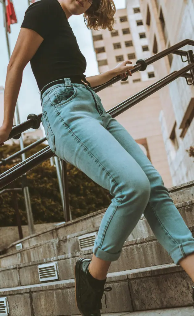 A girl is wearing a black t-shirt and jeans